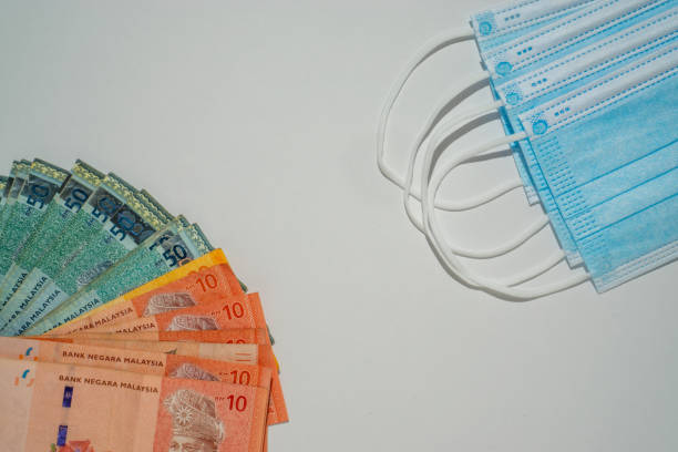 istock Medial face mask and a bundle of the MYR banknote 1286450680