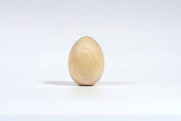 istock One vertical unpainted wooden egg isolated on a white background with a soft shadow. The Concept Of A Happy Easter 1286455254