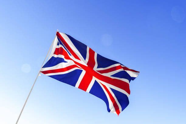 istock Flag of Great Britain waving against blue sky 1286455973