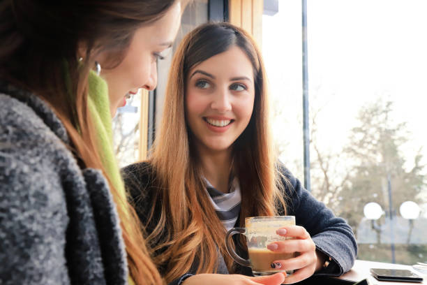 istock Two friends in a cafe 1286457156