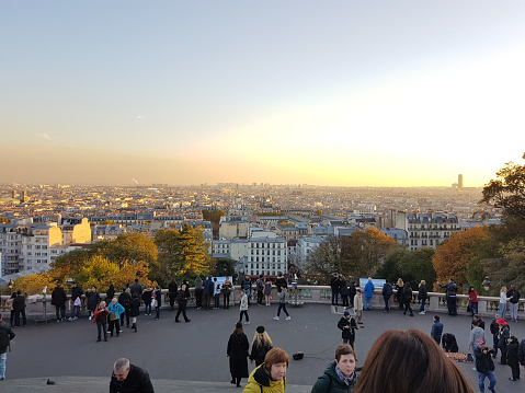 Paris, France - November 07, 2017: Montmartre is one of the best places to get a panoramic view, located in the north of Paris. It is the one of the highest points in the city of Paris and from the top you get the great view shown above. it is a very popular destination for both tourists and locals to take in the sun, shop and eat.
