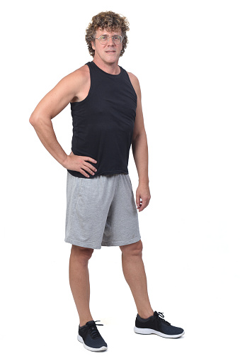 portrait of a man wearing sportswear tank tops and shorts on white background