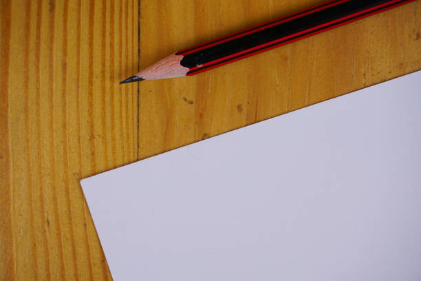 istock blank paper sheets and pen on wooden table. vintage copy space background concept 1286461941