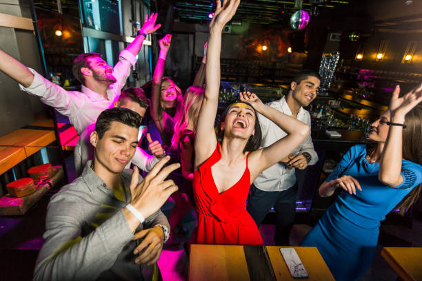 istock Young people dancing in night club 1286462323