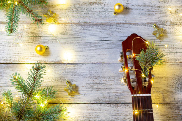 istock Guitar neck and Christmas tree with decorations and bokeh 1286463791