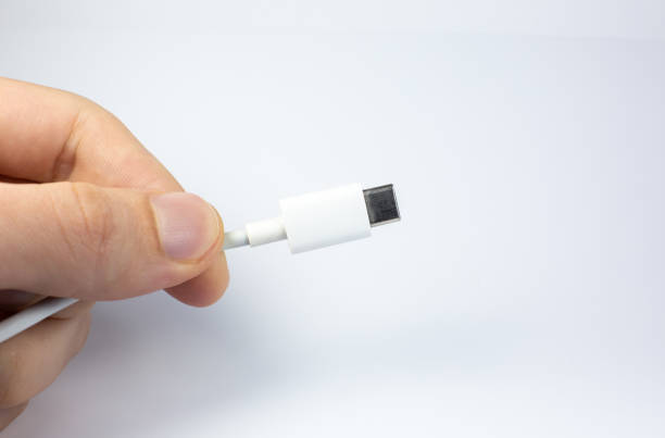 istock Man holding USB Type C Port Cable for charging. Close up photo. 1286463958