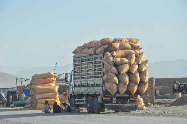 Overloaded Truck at truckstopp beside Highway to Kabul, Afghanistan, workers sitting in Shade making break, Afghanistan 08.10.2012