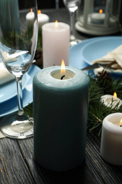 istock Concept of romantic New year table setting with candles on wooden table 1286465986