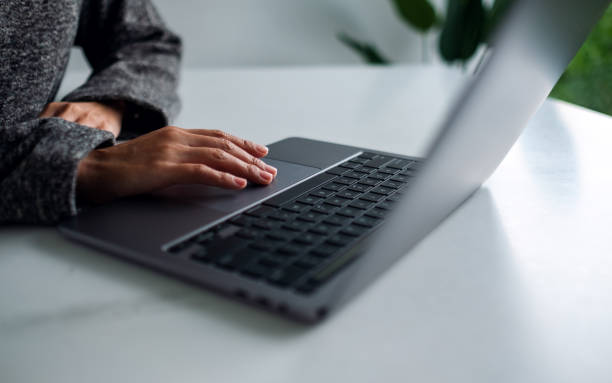 istock a woman working and touching on laptop computer touchpad on the table 1286466164