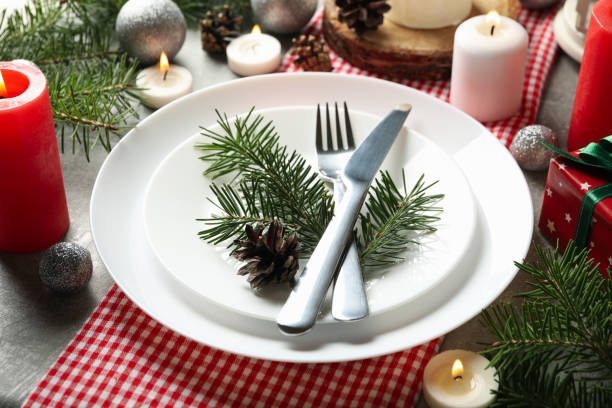 istock Concept of New year table setting with candles on gray table, close up 1286466203
