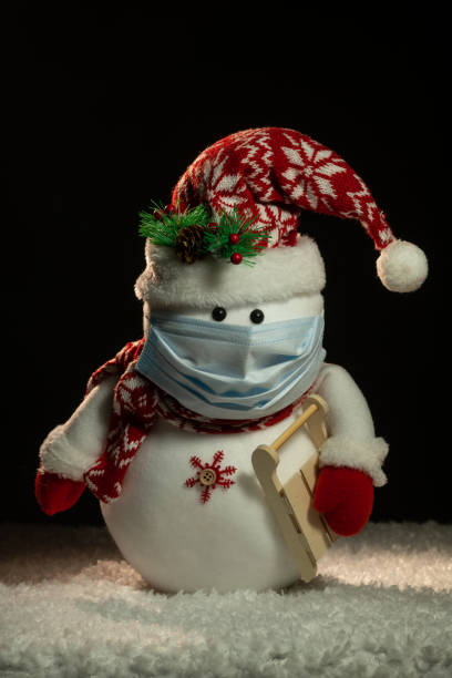 istock Toy snowman wearing  medical protective mask 1286468547
