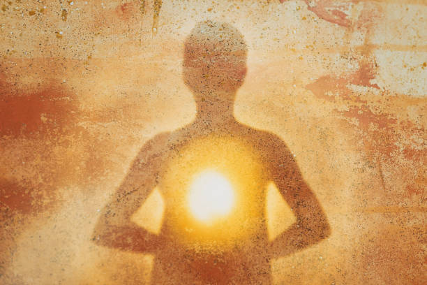 istock Female silhouette radiating light from within a spiritual heart opening 1286468774