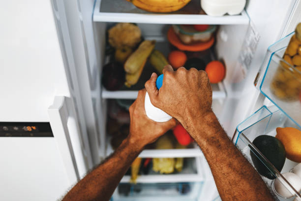 istock Male hands taking bottle of milk from a fridge 1286468790