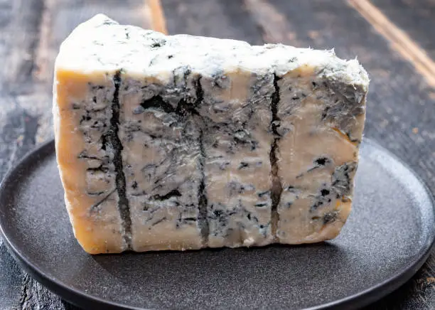 Cheese collection, piece of italian blue cheese gorgonzola picante with blue mold from north of Italy close up