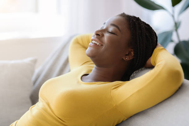 istock Domestic Relax. Smiling Black Lady Leaning Back On Couch With Closed Eyes 1286473190