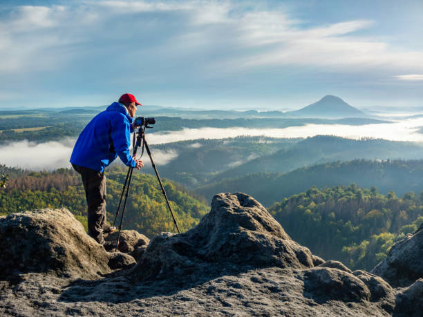 istock Silhouette of photographer working in mountain. 1286473740