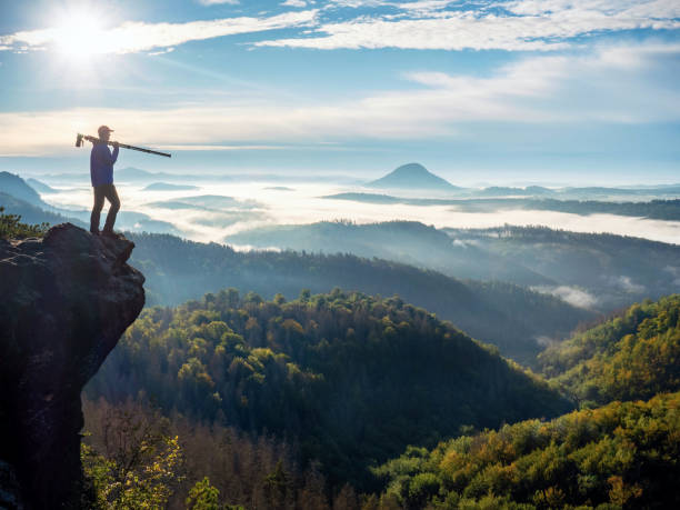 istock Hiker carry camera with tripod on his shoulder and loo 1286473794