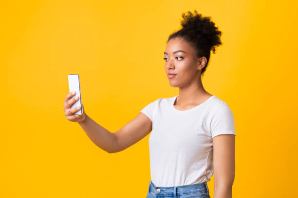 istock Black woman making video call using mobile phone 1286473901