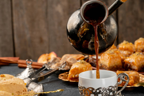 istock Cup of coffee and turkish pastries on dark surface 1286474071
