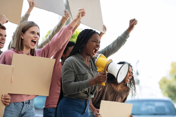istock Emotional international students making strike on the street, side view 1286474082