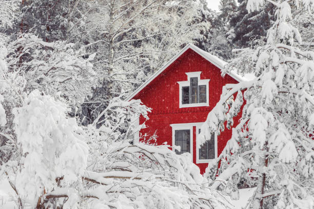 istock Red house in winter snow forest. 1286474122