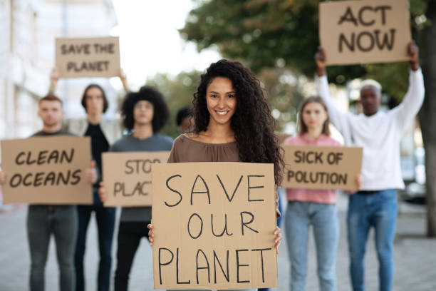 istock Cheerful lady with SAVE OUR PLANET placard 1286476833