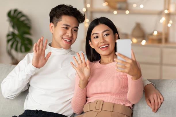 istock Japanese Couple Making Video Call Using Mobile Phone At Home 1286477484
