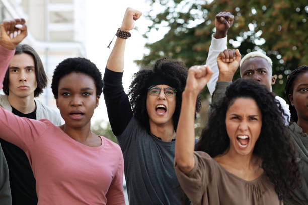 istock Students chanting slogans and showing fists during demonstration 1286477568