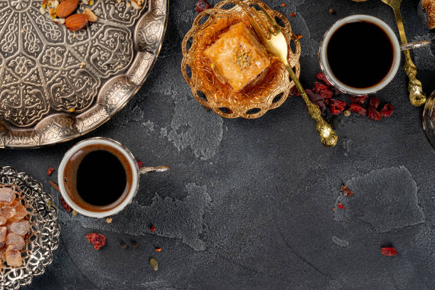 istock Cup of coffee and turkish pastries on dark surface 1286478093