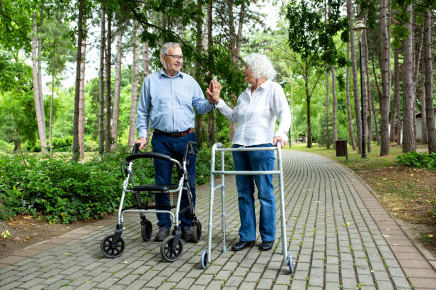 istock Elderly couple holding on to walking helper with one hand 1286479423