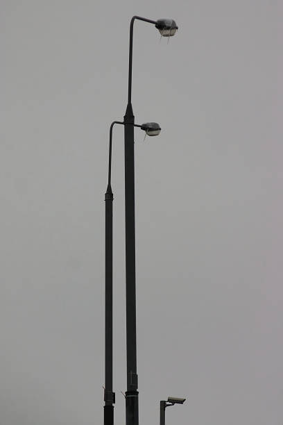 istock tall poles with lanterns against the gray sky 1286479508