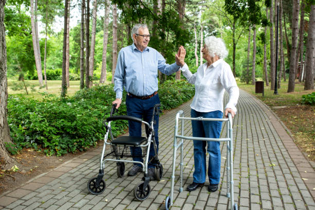 istock Senior couple in high five mode during a walk with helpers 1286479606