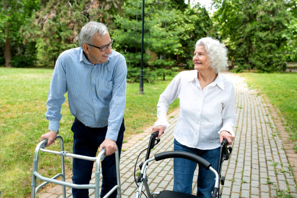 istock Elder man and a elder woman strolling in the park 1286479866