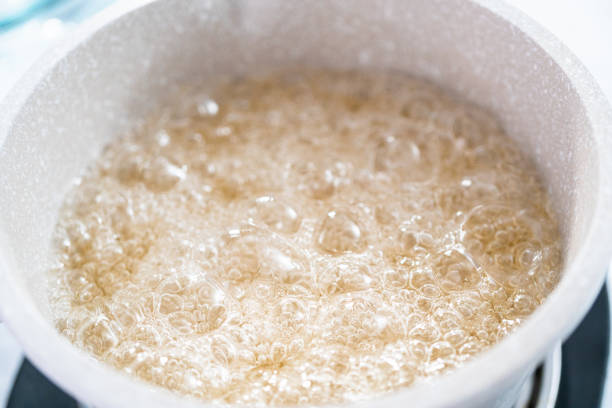 istock Caramelizing sugar in saucepan to make homemade lollipops. 1286482333