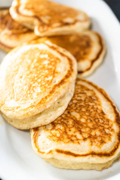 istock Freshly made pancakes on a white serving plate. 1286482825
