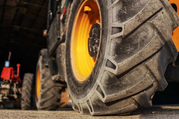 istock Closeup of tractor wheel on a farm. Everything is ready for work. 1286482827