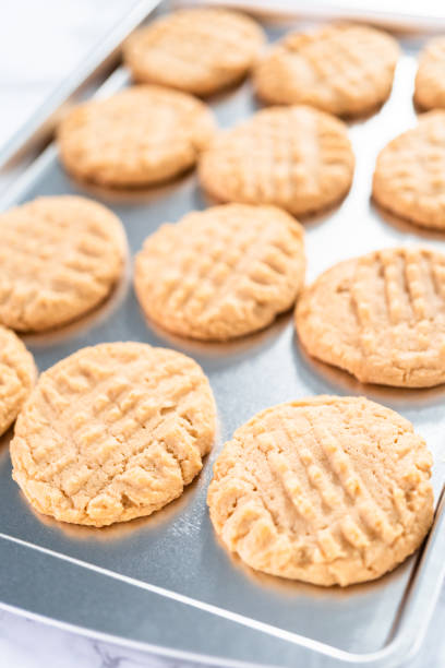 istock Freshly baked peanut butter cookies on a baking sheet. 1286482864