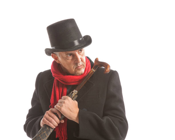 istock Elegant man in coat and top hat gesturing with umbrella 1286483665