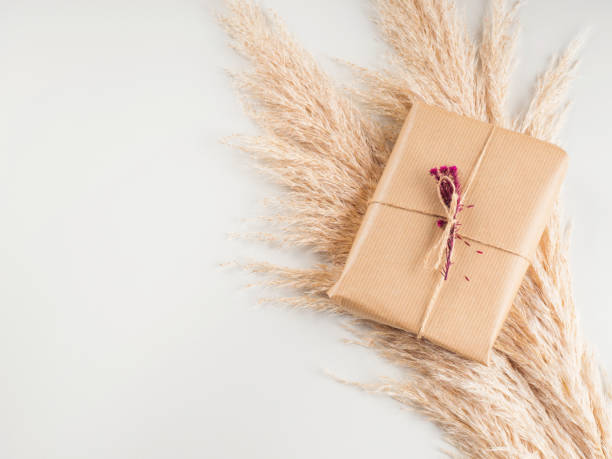 istock Gift boxes wrapped in craft paper with dried flowers 1286485475