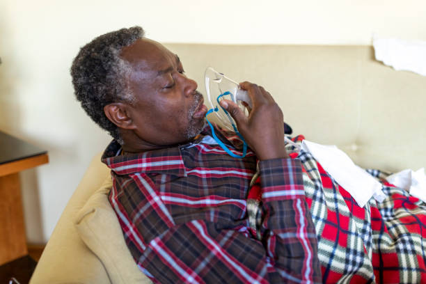 istock Sick Senior African with Pneumonia is Using Inhaler 1286485889