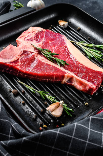 istock Porterhouse raw steak. Organic meat beef. Black background. Top view 1286486991