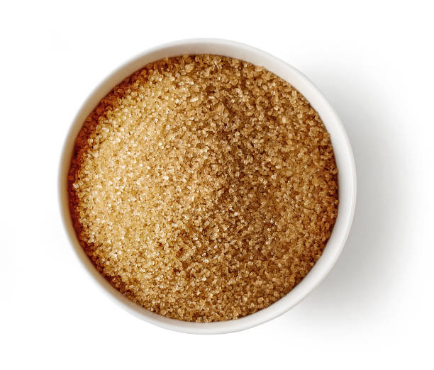 istock Bowl of brown sugar isolated on white background, top view 1286487189
