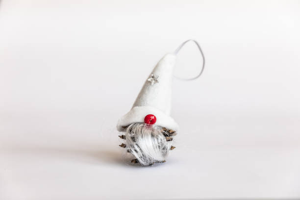 Troll. Christmas decorations. small gnome on a white isolated background. dwarf gnome with a red nose and a large cap covering the eyes. Copy Space