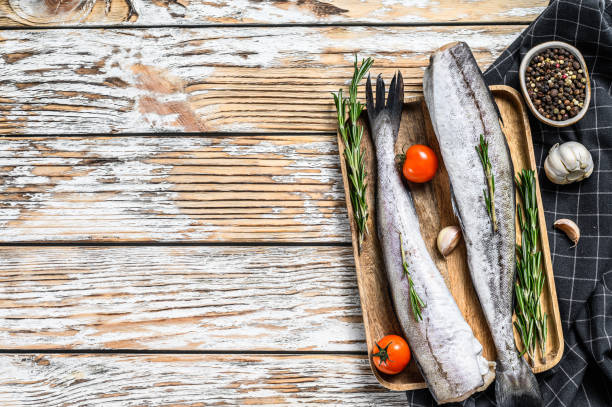 istock Fresh Pollock fish. Raw seafood. White wooden background. Top view. Copy space 1286487608