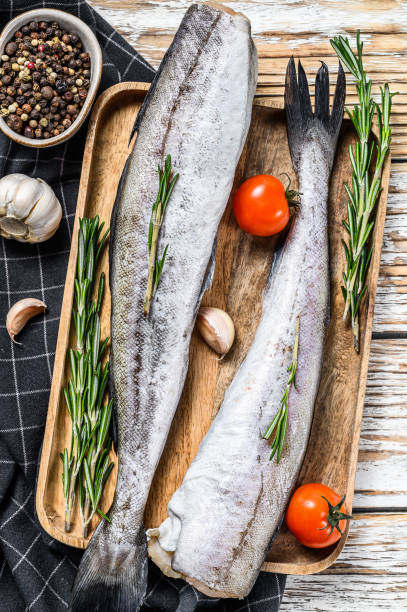 istock Fresh Pollock fish. Raw seafood. White wooden background. Top view 1286487638