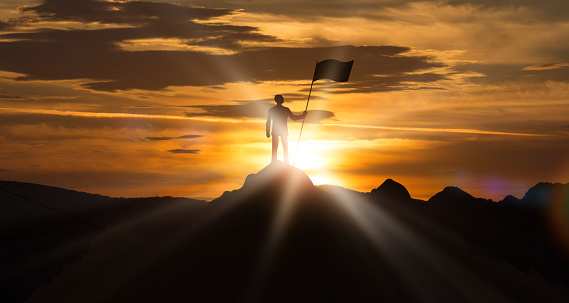 Success, Personal Achievement. Man Standing On The Top Of Mountain Hill Holding Flag Outdoor, Beautiful Daybreak Dawn Landscape. Set And Achieve Goal. Leadership, Motivational Background. Panorama