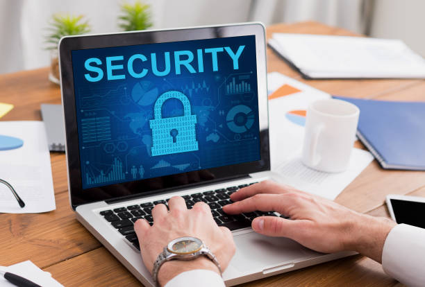 istock Businessman typing on laptop keyboard, padlock icon on the screen 1286490309