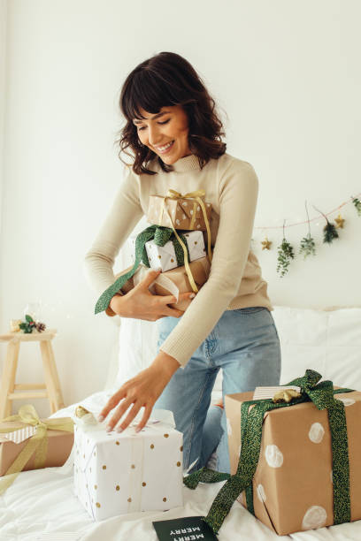 istock Woman collecting her christmas presents 1286491223