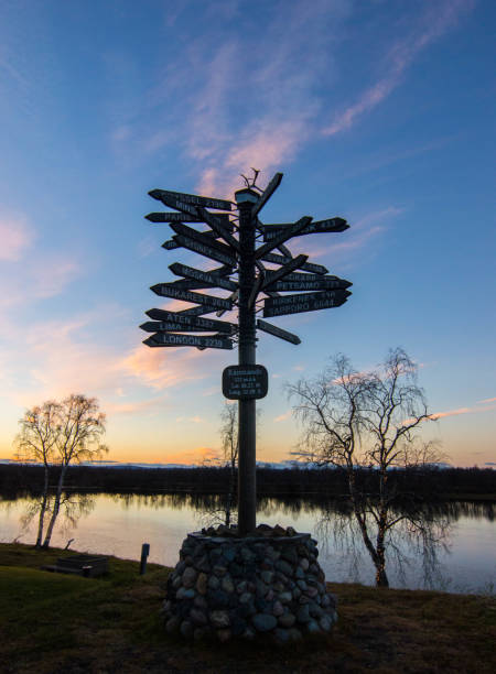 Karesuando, Sweden - October 2018 Karesuando (Gárasavvon in Sami) is the northernmost church village in Sweden located 260km above the Arctic Circle.
This is a famous crossroad sign indicating the distance to  some of the main cities of the world. costantino stock pictures, royalty-free photos & images