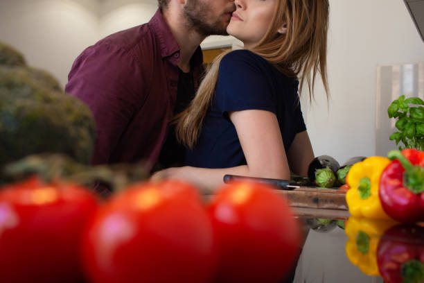 istock Young couple share a romantic moment while cooking 1286494052
